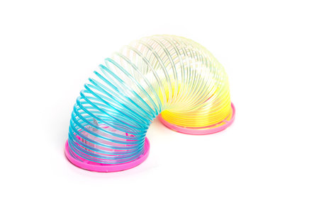 Toy plastic colorful rainbow spiral for play isolated on whiteの写真素材