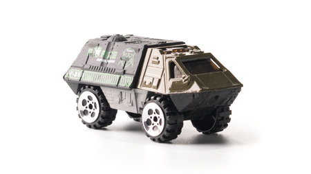 Plastic model of a military SUV toy car isolated on white background.