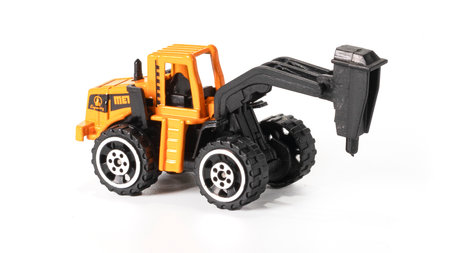 Tractor toy for road works. Construction Equipment Toys isolated on white.