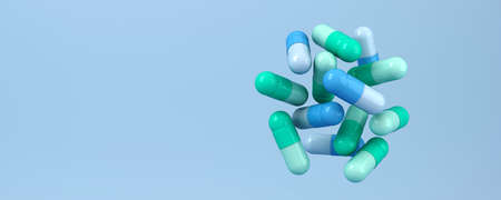 Blue green pills on blue background. Medical 3d illustration.の写真素材