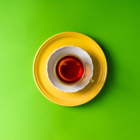 Tea in glass cup on green background. Flat lay.の写真素材