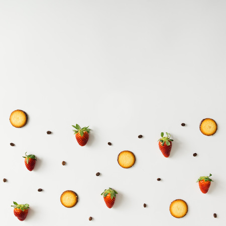 Colourful pattern made of coffee beans, strawberries and cookies.の写真素材