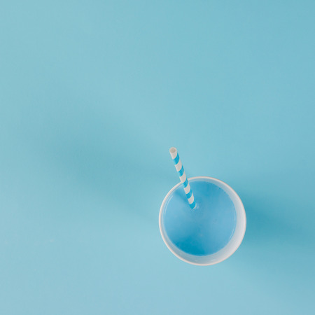 Blue drink with straw. Flat lay minimal concept.の写真素材