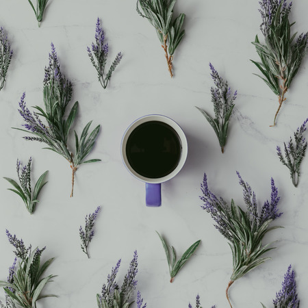 Creative mock up layout made of lavender branches with coffee cup on table. Homemade flat lay concept.の写真素材