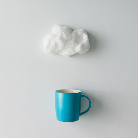 Cup of coffee with cotton wool cloud. Flat lay. Weather conceptの写真素材