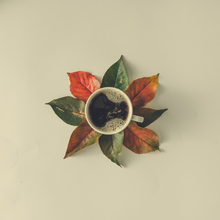 Creative autumn layout with leaves and coffee cup. Flat lay. Fall cocncept.の写真素材