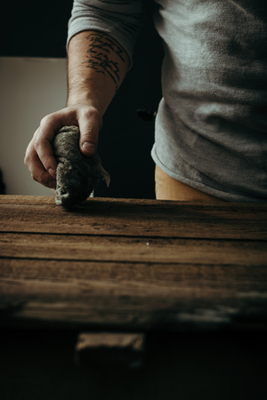 Hard working male hand cleaning or polishing wooden deskの写真素材