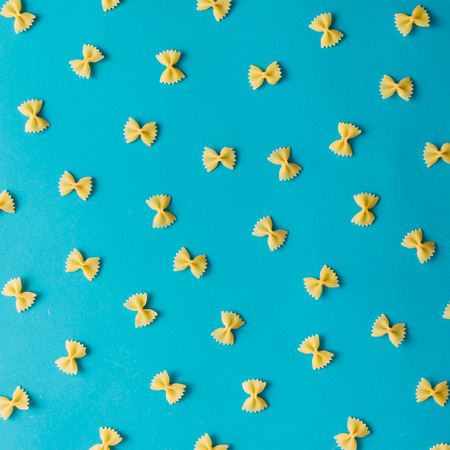 Pattern made of pasta on blue background. Flat lay.の写真素材