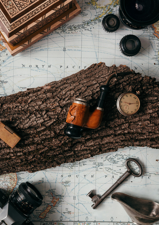 Flat lay adventure vintage gear for exploring or traveling on old map