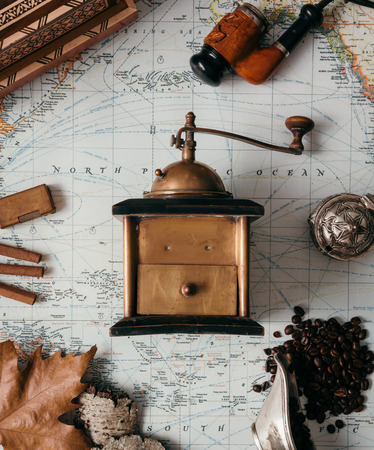 Flat lay adventure vintage gear for exploring or traveling on old mapの写真素材