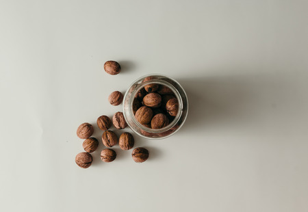 Top view of old glass jar with walnutsの写真素材
