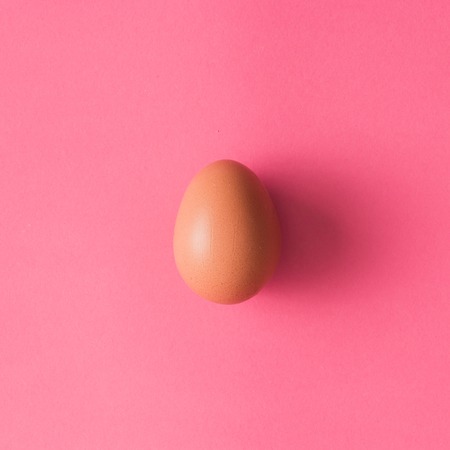 Top view of egg on pink backgroundの写真素材