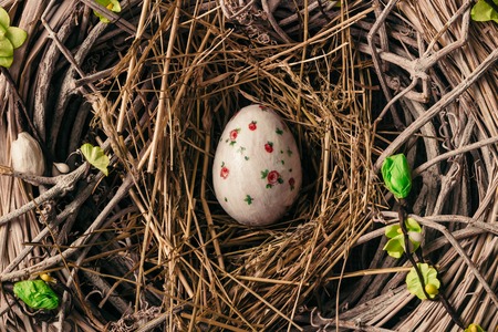 Decorated Easter egg in bird nestの写真素材