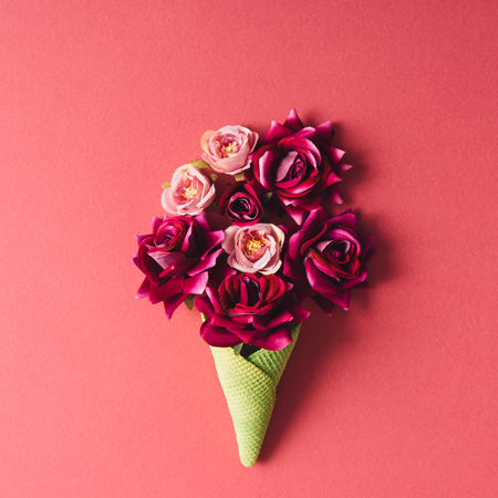 Purple flowers and green icecream cone on pink background. Flat lay.の写真素材