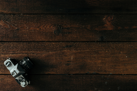 Top view of camera on old wooden deskの写真素材