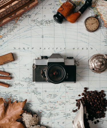 Flat lay adventure vintage gear for exploring or traveling on old mapの写真素材