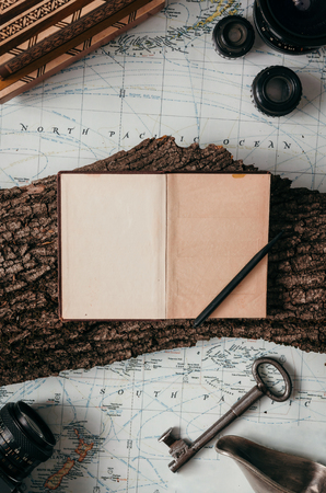 Flat lay adventure vintage gear for exploring or traveling on old mapの写真素材