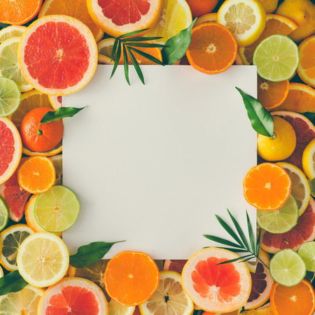 Creative layout made of fruits with white paper card note. Flat lay. Tropical concept.の写真素材