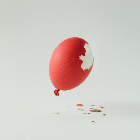 Red Easter egg balloon on bright white background. Minimal creative concept. Flat lay.の写真素材
