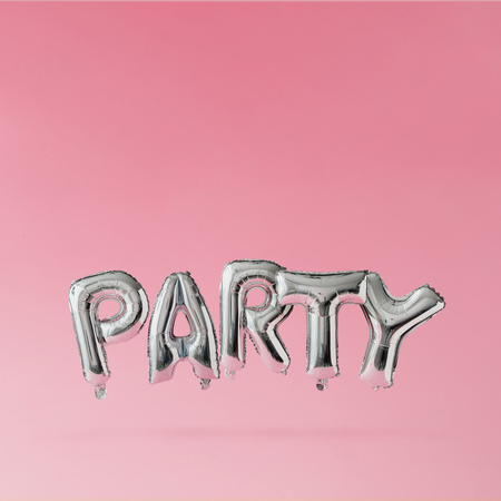 Party ballons floating on pink pastel background. Celebration concept.の写真素材