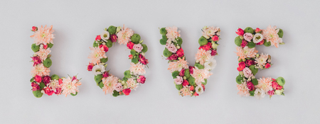 Word LOVE made of various flowers. Valentines day flat lay. Nature love concept.の写真素材