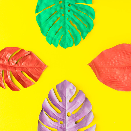 Painted tropical and palm leaves in vibrant bold colors. Concept art. Minimal summer colorful background.の写真素材