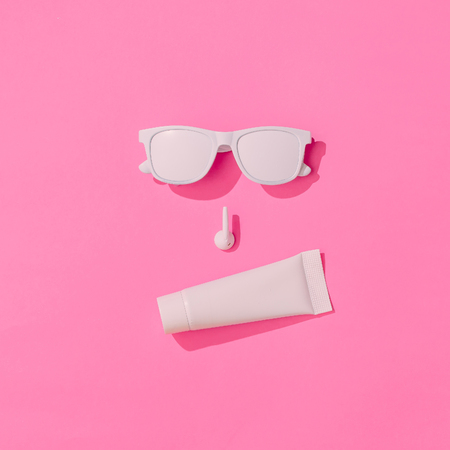 Creative hipster layout with copy space and various summer objects on pastel pink background. Minimal vacation concept. Flat lay.の写真素材