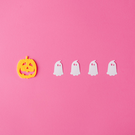 Creative layout made with Jack-o'-lantern and ghosts. Minimal flat lay. Halloween concept.の写真素材