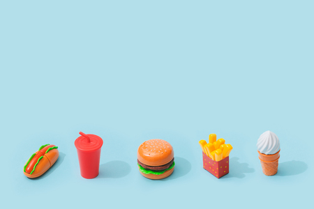 Fast food items on pastel blue background. Junk food minimal concept.の写真素材
