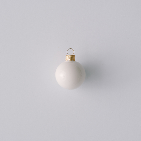 White Christmas ball Ornament on pastel gray background. minimal concept idea.  Flat lay, top view. Christmas sale card concept.の写真素材