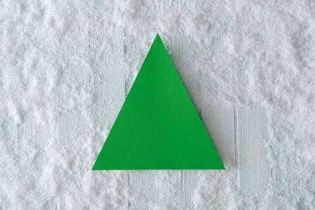 White wooden table background with snow and green minimal Christmas tree copy space paper card. Winter top view. Flat lay.の写真素材