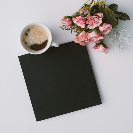 Creative winter natural composition with flowers and coffe cup. Flat lay, table top view. Greeting card copy space.の写真素材