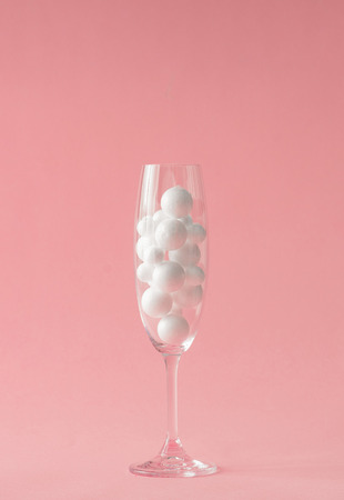 Champagne glass with white bubbles. Minimal party composition.の写真素材