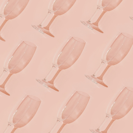 Minimal style. Champagne glasses on pastel coral background.の写真素材