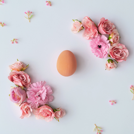 Creative layout made of colorful spring flowers and green leaves.  Minimal Easter concept. Flat lay pattern.の写真素材