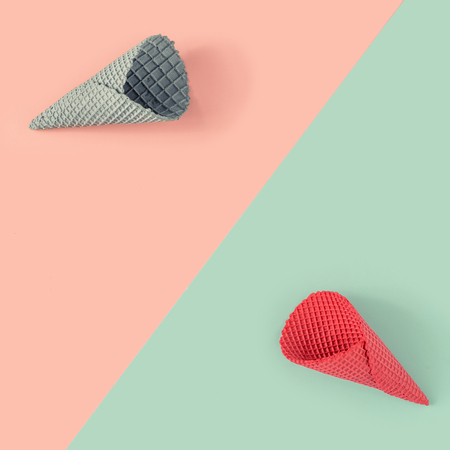 Ice cream cones in pastel pink and blue colors on paper duotone background. Minimal summer concept. Flat lay.の写真素材