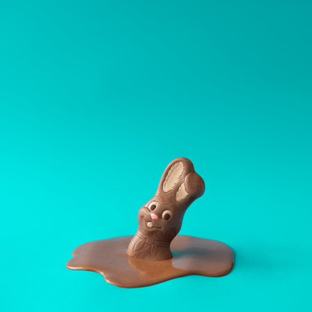 Easter chocolate bunny rabbit melting. Creative Easter holiday concept background. Minimal style.の写真素材
