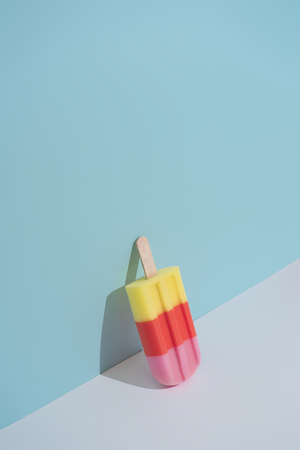 Colorful Ice cream on pastel blue background. Minimal summer composition.の写真素材
