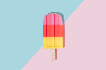 Ice cream in pastel pink on paper duotone background. Minimal summer concept. Flat lay.