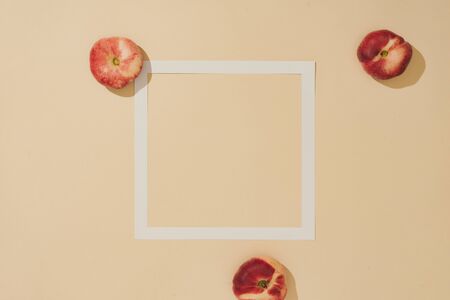 Minimal sunlit fruit composition with sand colour background and sharp shadows. Summer creative copy...