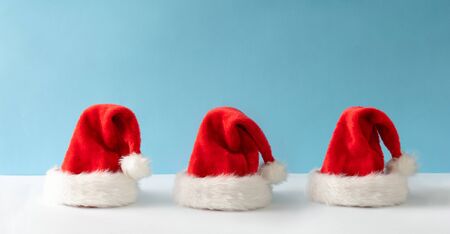 Creative Santa Claus hat with bright background. Minimal winter flat lay Christmas concept. Merry Christmasの写真素材