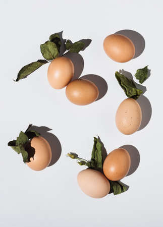 2021 Easter real unique still life composition. Eggs with dry natural leaves. Flat lay minimal...
