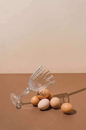 2021 Easter real unique still life composition. Eggs with champagne glass. Creative retro minimal...