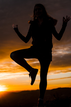 SUNSET GIRL SILHOUETTEの写真素材