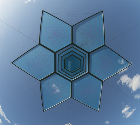 Six pointed star design object over blue skyの写真素材