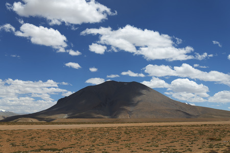 Lonely mount shadowed by clouds