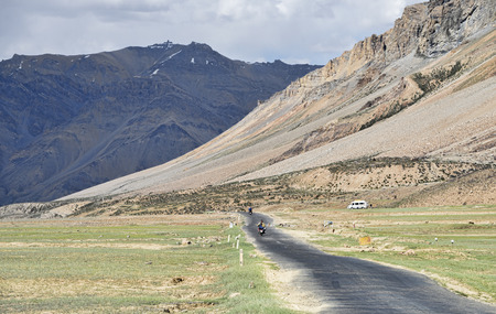 Biker riding at valley in mountainsの写真素材