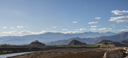 Panoramic view of Buddhist temple on hill with mountains backgroundの写真素材