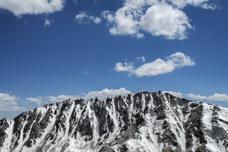 Snow covered sharp mountain ridgeの写真素材