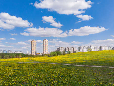 Aerial drone shoot with top view of Minsk, Belarus. Modern architecture, yellow field, trees, blue sky. Sun shining. 10th June 2020のeditorial素材